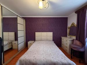 a bedroom with a large bed and a mirror at Tevosyan Gold EVN Airport in Pʼarakʼar