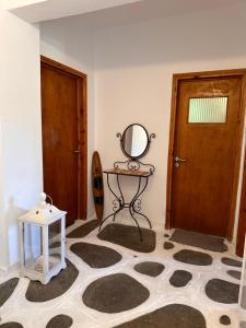 a room with a mirror and a table and a door at Villa Ethel Vourvourou in Vourvourou