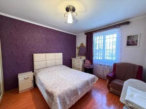 a bedroom with a bed and a chair at Tevosyan Gold EVN Airport in Pʼarakʼar