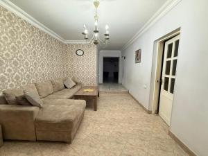 a living room with a couch and a table at Tevosyan Gold EVN Airport in Pʼarakʼar