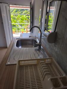 a kitchen sink with a faucet next to a sink at Casa Verde in Lukovë +7 photos
