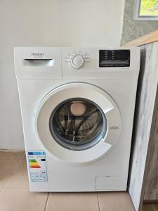 a white washing machine in a room at Casa Verde in Lukovë