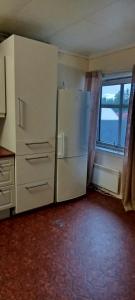 a kitchen with a refrigerator and a window at Eina house near the E4 road in Eina
