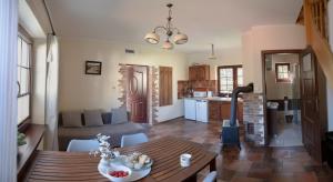 a kitchen and a living room with a table and a dining room at Zaciszna Przystań Dębina in Debina +25 photos