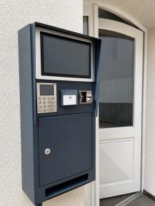 a vending machine with a television on the side of a door at Hotel-Restaurant Alt Karow in Berlin