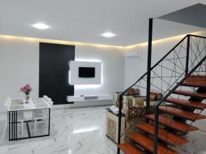 a living room with a staircase and a tv at redHome in Gabala
