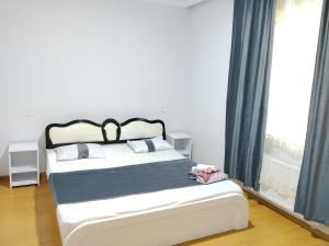 a bedroom with a bed and a large window at redHome in Gabala +20 photos