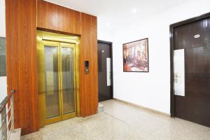 a hallway with a glass door in a building at Collection O Tipsyy Inn in Gurgaon