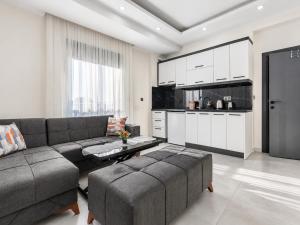 a living room with a couch and a kitchen at The Orange Cactus in Antalya