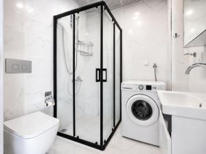 a white bathroom with a washing machine and a sink at The Orange Cactus in Antalya +26 photos