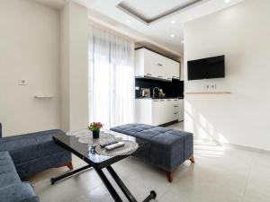 a living room with a couch and a table at The Orange Cactus in Antalya