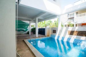 a swimming pool in the backyard of a house at Classic Horizon in Mahabalipuram