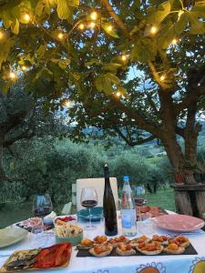 a table with wine glasses and food and wine bottles at Poderino - a place to feel in Cento