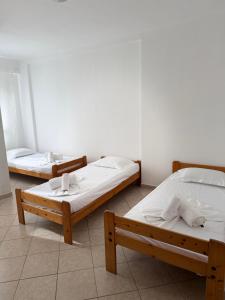 two beds sitting in a room with at Saranda Port View Apartments in Sarandë