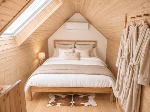 a bedroom with a large bed in a attic at Tourist Farm Ranč Velka in Spodnja Velka +43 photos