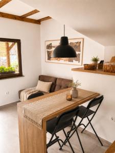a living room with a table and a couch at Tourist Farm Ranč Velka in Spodnja Velka