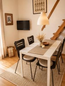 a white dining room table with black chairs at Tourist Farm Ranč Velka in Spodnja Velka