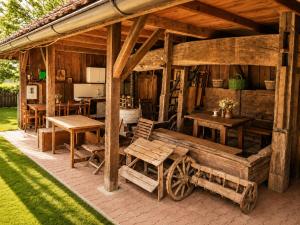 a wooden pavilion with a wooden bench and tables at Tourist Farm Ranč Velka in Spodnja Velka