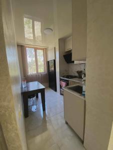 a kitchen with a table and a counter top at Apartment Entier apartment in Chakvi