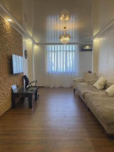a living room with a couch and a table and a chandelier at Apartment Entier apartment in Chakvi