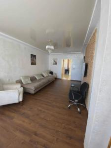 a living room with a couch and a chair at Apartment Entier apartment in Chakvi