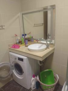 a bathroom with a sink and a washing machine at Apartment Entier apartment in Chakvi