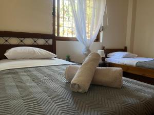 a bedroom with two beds with towels on it at Andrew's place in Metogjashta