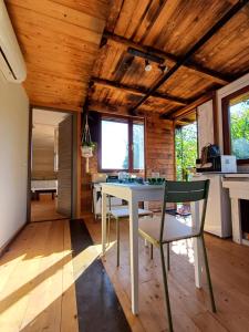 a kitchen and dining room with a white table and chairs at Jasmine & Rose House in Udine