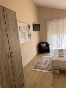 a room with a bed and a large wooden door at Sunrise house apartments in Ulcinj