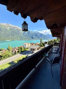 a balcony with a view of a lake and mountains at Chalet Luna - Alpine Apartment by Lake Brienz in Niederried +37 photos