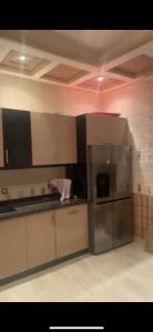 a kitchen with a stainless steel refrigerator in a room at marrakesh Big house in Marrakesh