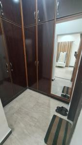 a room with a mirror and a closet at Classy home in Lahore