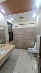 a bathroom with a sink and a toilet in it at Classy home in Lahore