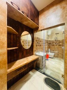 a bathroom with a shower and a sink and a mirror at shyam hotel rexa in Vrindāvan
