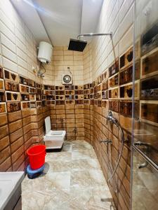 a bathroom with a shower and a toilet and a sink at shyam hotel rexa in Vrindāvan +15 photos