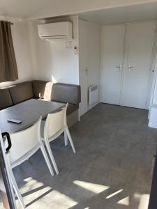 a small room with a table and a couch at Camping Carnac in Carnac