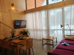 a living room with a table and a couch at Harasiuki House in Harasiuki