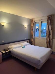 a large bed in a room with a window at Hôtel du Lac in Lacapelle-Viescamp +80 photos