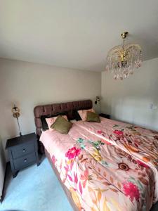 a bedroom with a bed and a chandelier at Whispering Pines in Retie