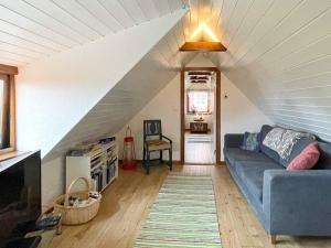 a living room with a blue couch in a attic at 8 person holiday home in Beddingestrand-By Traum in Beddinge Strand