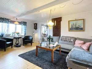 a living room with a couch and a table at 8 person holiday home in Beddingestrand-By Traum in Beddinge Strand