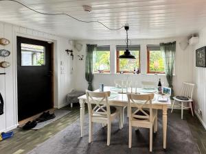 a dining room with a white table and chairs at 8 person holiday home in Beddingestrand-By Traum in Beddinge Strand