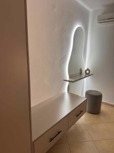 a white desk with a light on the wall at Sunrise house apartments in Ulcinj +80 photos