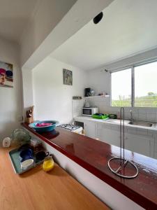 a kitchen with a wooden counter top in a room at Corossole in Bouillante