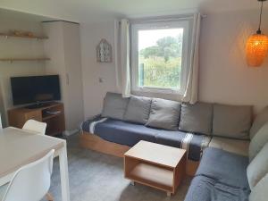 a living room with a couch and a window at HerGine in Pérols