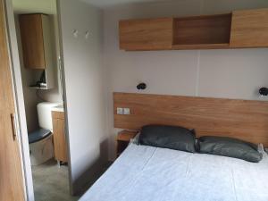 a bedroom with a bed with a wooden headboard at HerGine in Pérols +12 photos