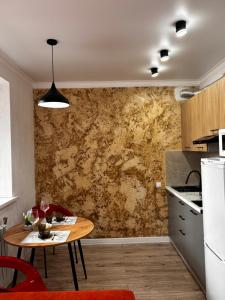 a kitchen with a table in a room with a wall at Жк сокол in Kokshetau