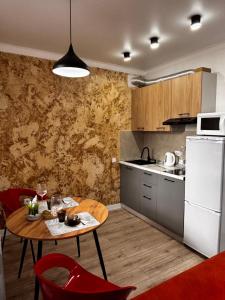 a kitchen with a table and red chairs in a room at Жк сокол in Kokshetau