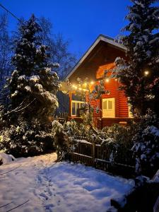 a house with christmas lights on it in the snow at Vacations for a good cause in Drochtersen