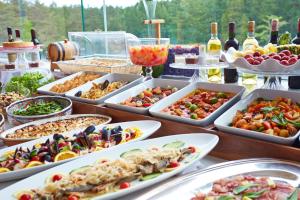 a table with many dishes of food and bottles of wine at Fuji Premium Resort in Fujikawaguchiko